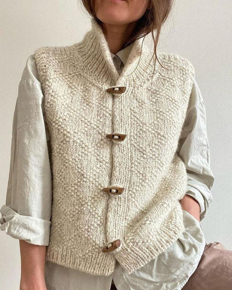 Cream sleeveless knit cardigan with front toggle buttons and ribbed hem