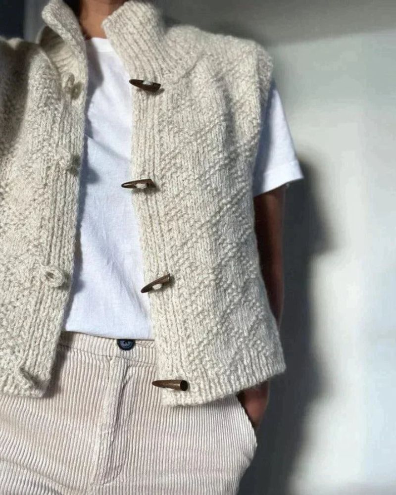 Cream sleeveless cardigan vest with front toggle buttons and stand collar