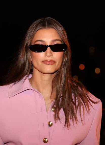 Black sunglasses worn by model with dark lenses