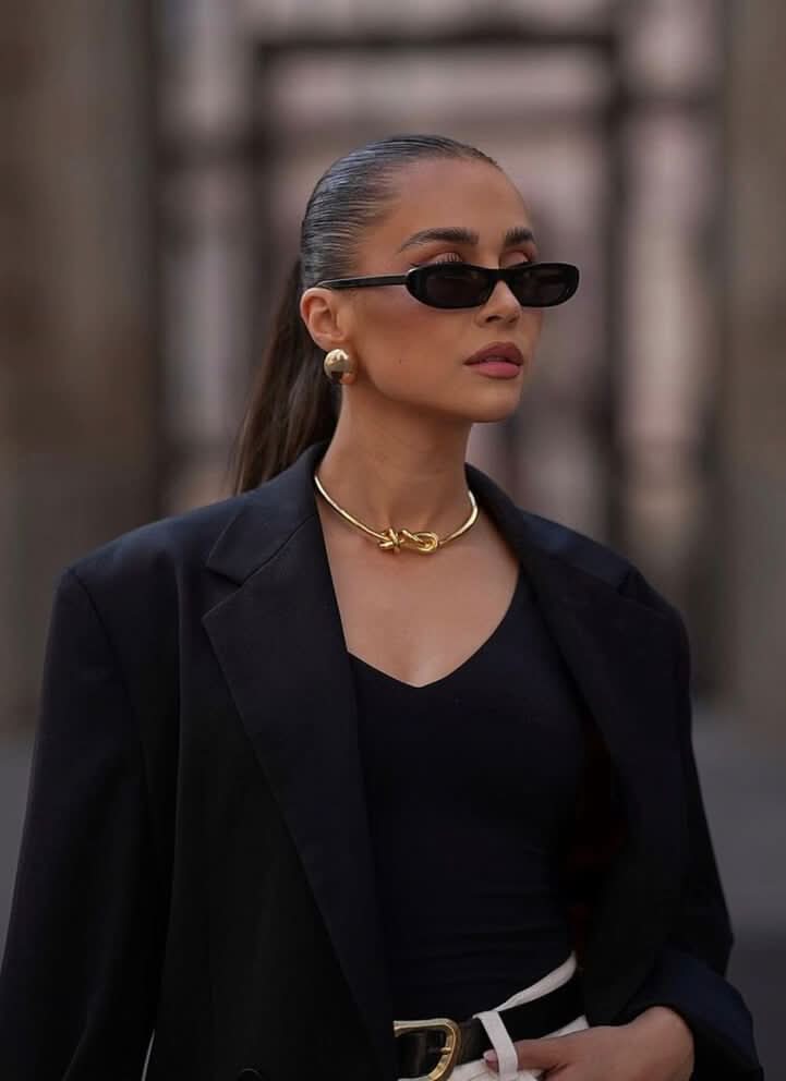 Black sunglasses worn by model with dark lenses