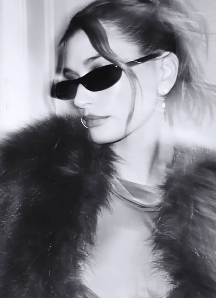 Black sunglasses worn by model with dark lenses