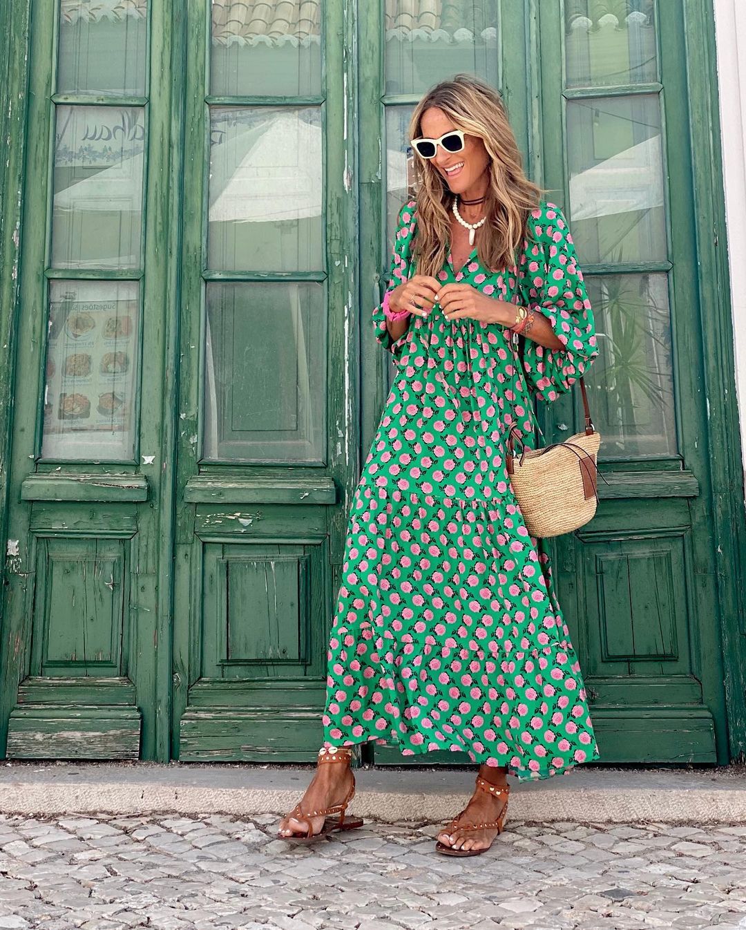 Green spring dress with pink rose print, long tiered skirt and V-neckline