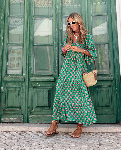Green spring dress with pink rose print, long tiered skirt and V-neckline