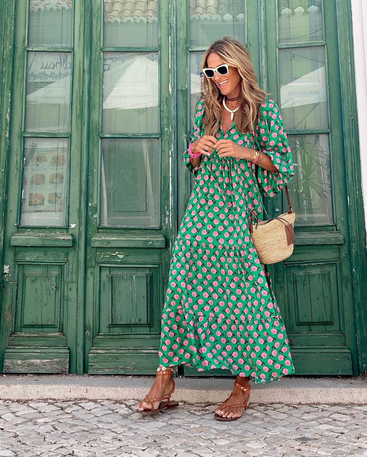 Green spring dress with pink rose print, long tiered skirt and V-neckline