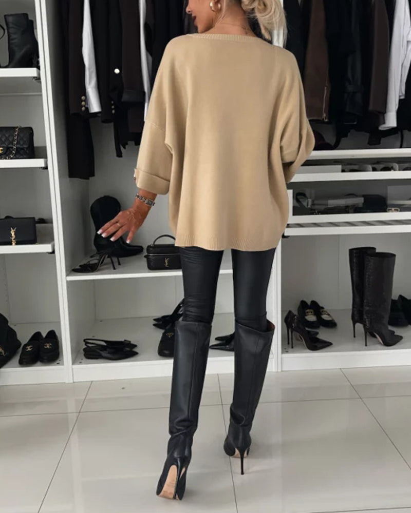 Beige cosy buttoned pullover sweater back view, loose fit with buttoned sleeve cuffs