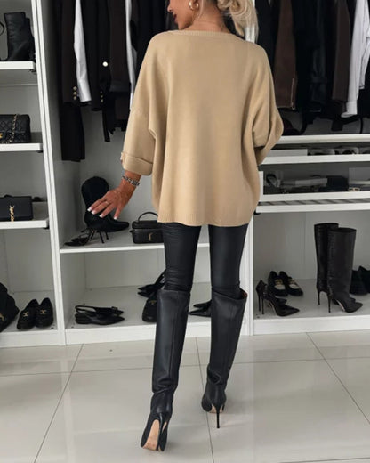 Beige cosy buttoned pullover sweater back view, loose fit with buttoned sleeve cuffs