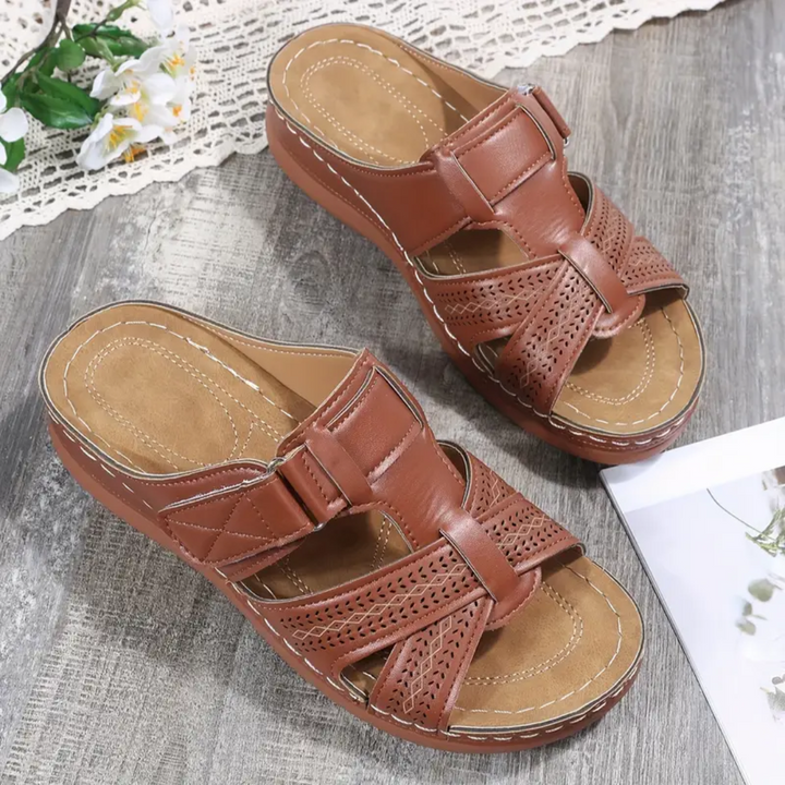Rust brown ergonomic sandals with perforated straps and buckle