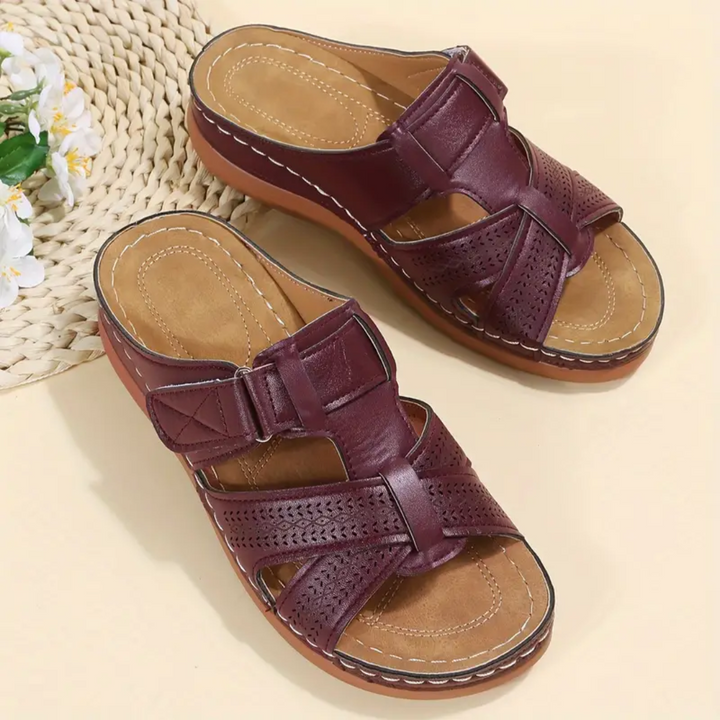 Burgundy ergonomic sandals with two straps, perforated sections, and tan footbed
