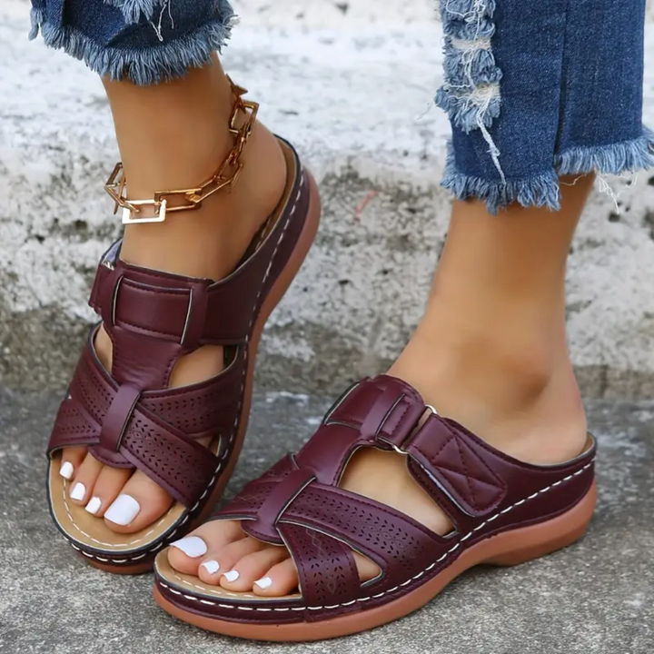 Burgundy ergonomic sandals with ankle strap, perforated toe, and buckle closures