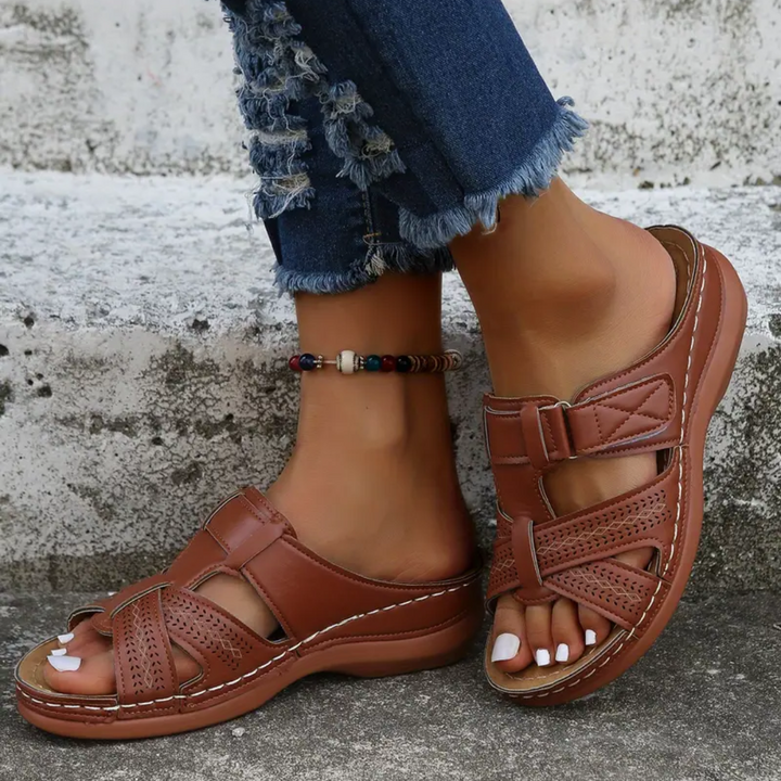 Tan ergonomic sandals with front straps and perforated toe panels, adjustable buckle