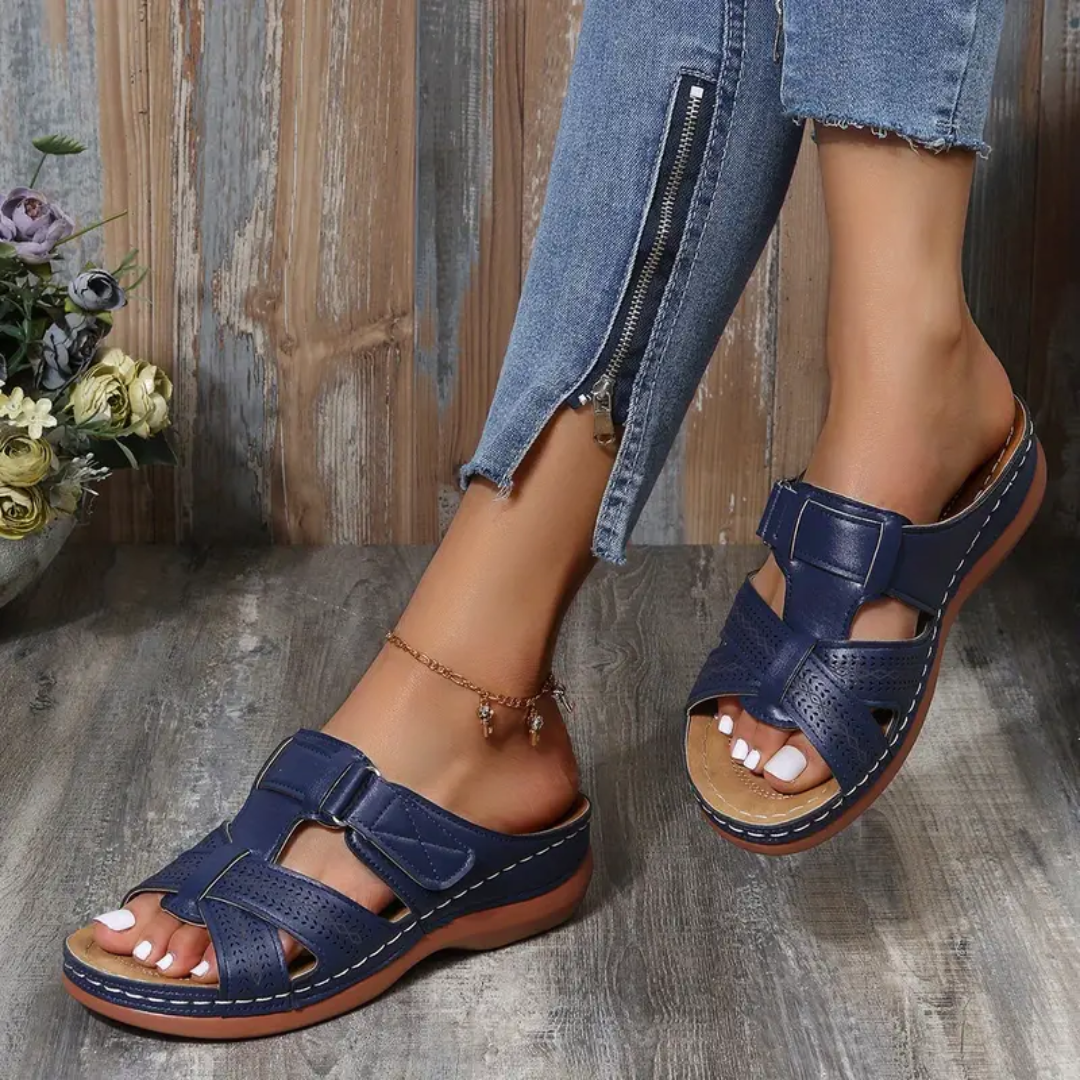 Navy ergonomic sandals with two adjustable straps, perforated upper, and tan footbed