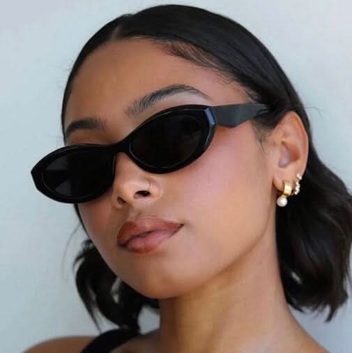 Black cat-eye sunglasses close-up with dark lenses on face