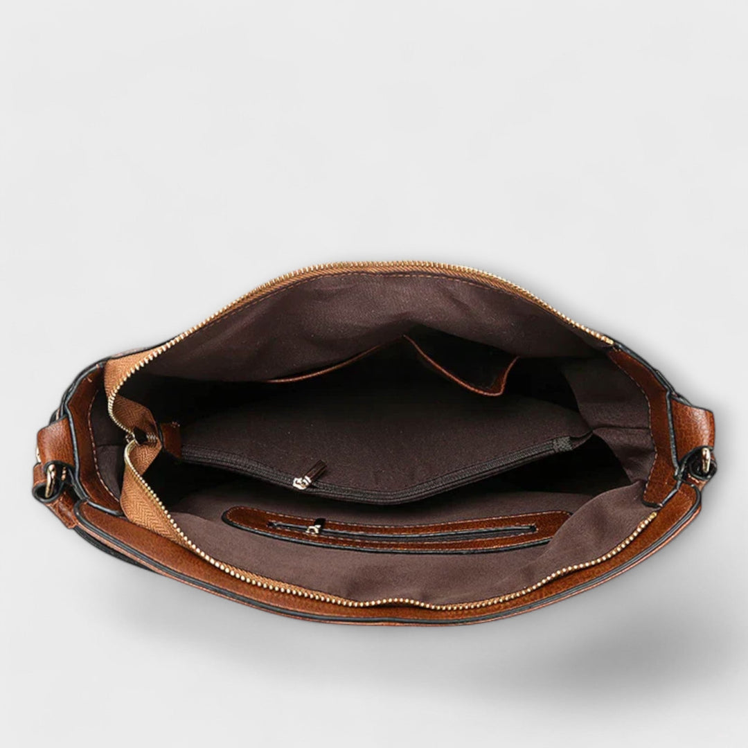 Brown hobo handbag interior view with zip closure and lined compartment