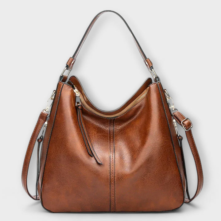 Large hobo handbag in brown leather-look with front zip pocket and tassel pull straps