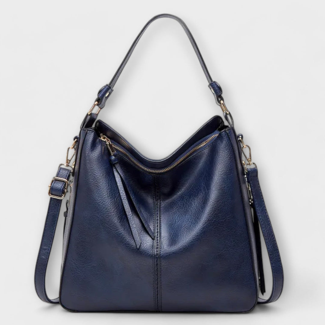 Large hobo handbag in navy-blue leather-look with front zip pocket and tassel pulls