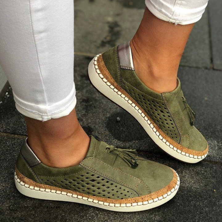 Green orthopedic slip-on shoes with tassel detail, perforated upper, and cream sole