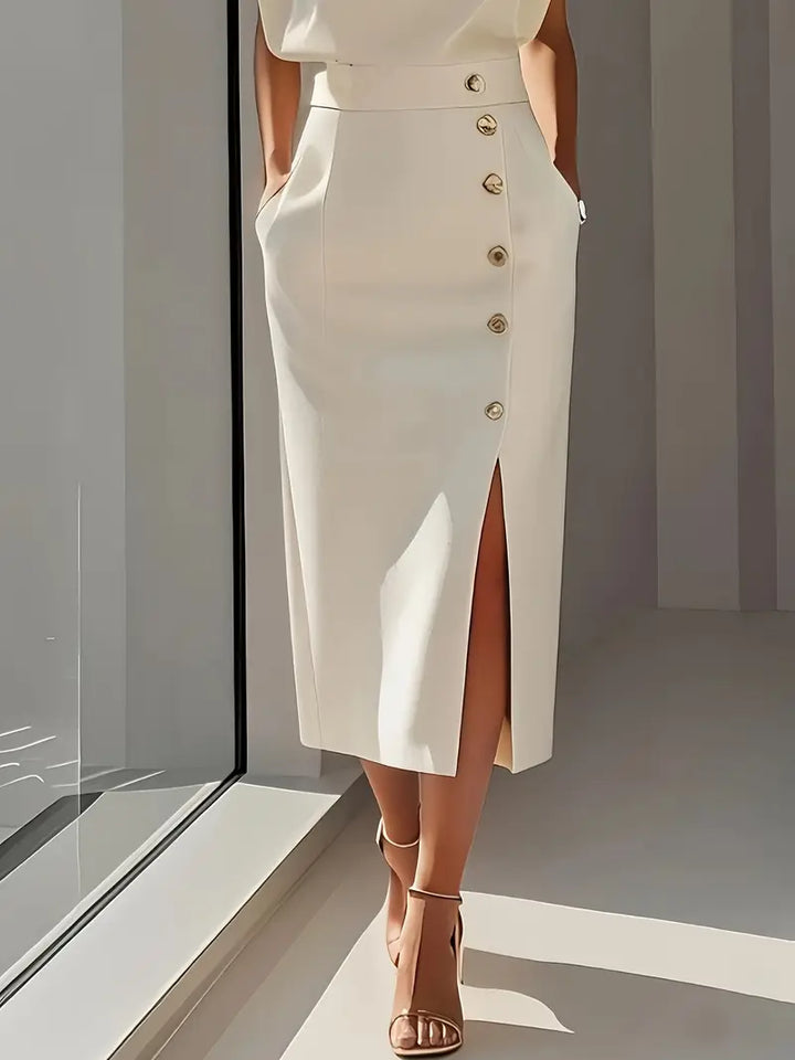 Cream midi dress front, fitted waist with gold buttons and side slit.