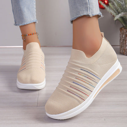 Beige knit slip-on sneakers with multicolor stripe detail and cushioned white sole
