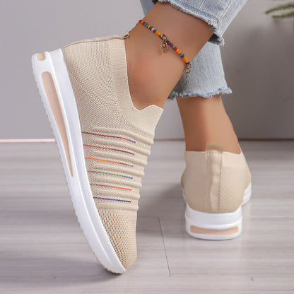 Beige knit slip-on sneakers with multicolor stripe detail and white sole, back view