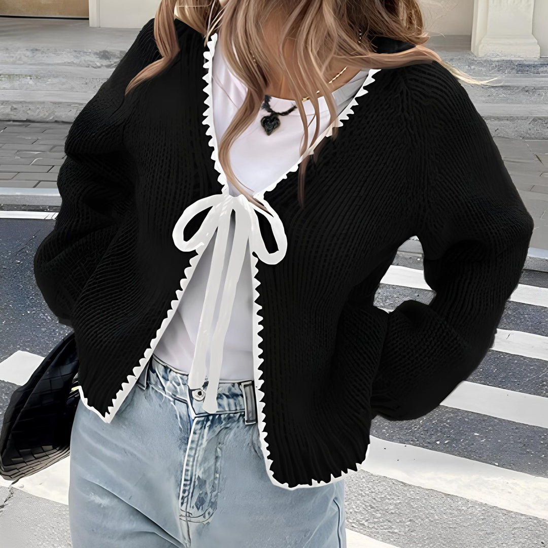 Black open-front long sleeve cardigan with scalloped edge and white ribbon tie