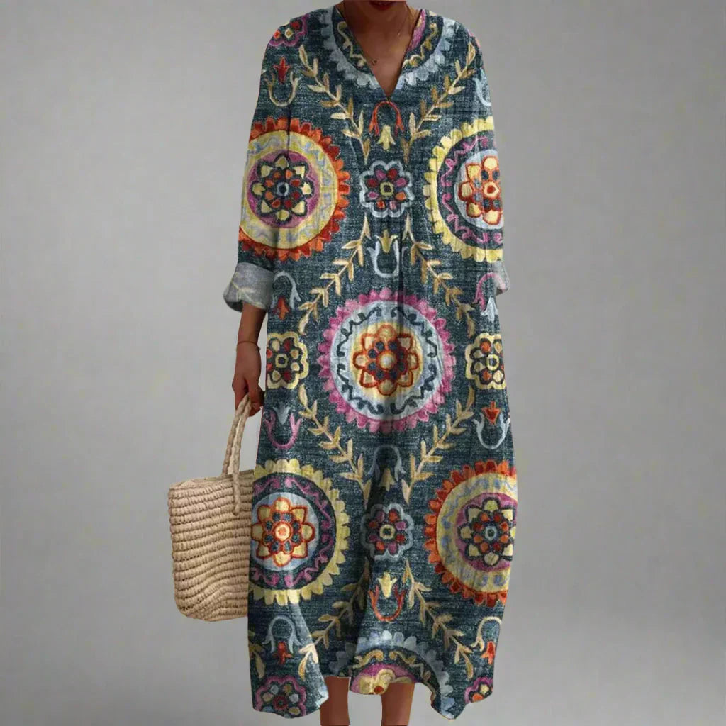 Geometric print maxi dress with V-neck, long sleeves, and multicolor medallion pattern.