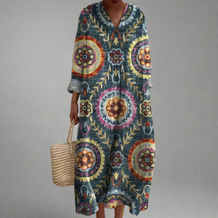 Geometric print maxi dress with V-neck, long sleeves, and multicolor medallion pattern.