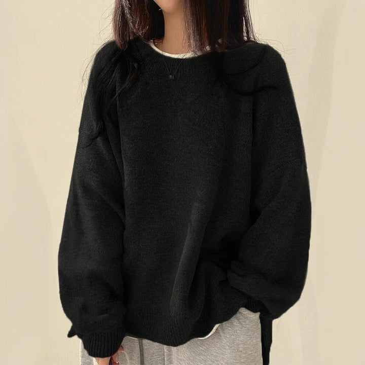 Black oversized knit sweater with crew neck, long sleeves, ribbed cuffs and hem.