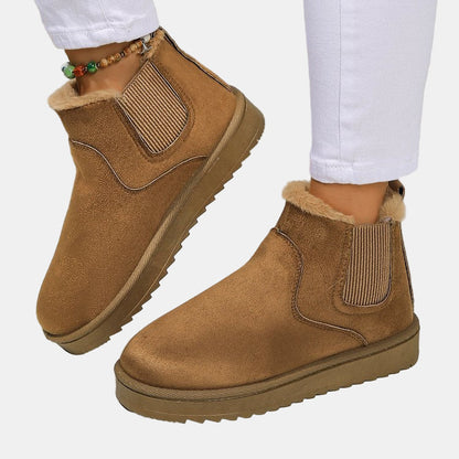 Brown cozy ankle boots with faux fur cuff and elastic side gusset, rugged sole