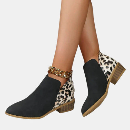 Black ankle boots with leopard-print side panels, gold chain detail, and block heel