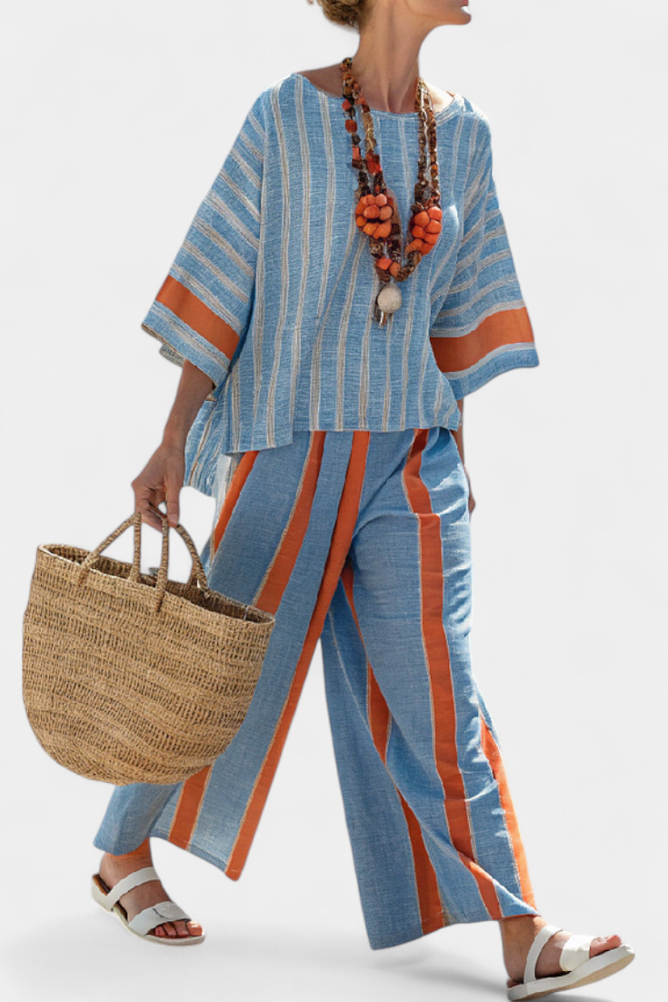 Back view: blue striped top with orange cuff trim and striped linen trousers