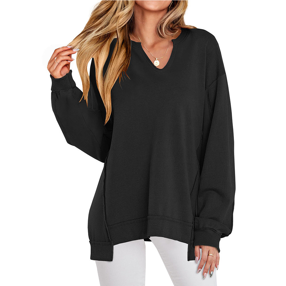 Oversized long-sleeve top in black with V-neck and gathered cuff detail