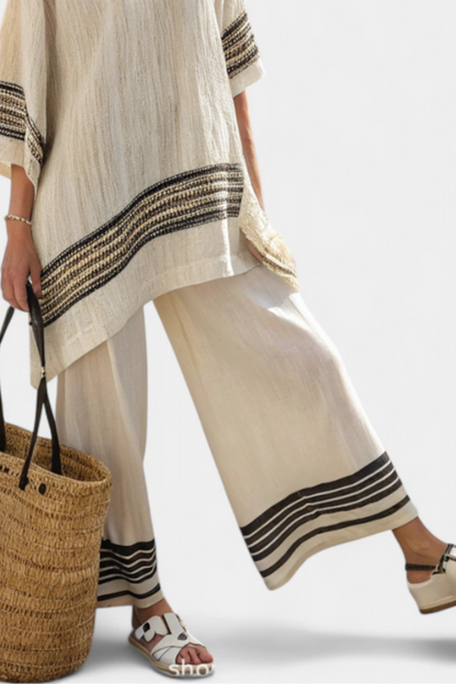 Wide-leg linen trousers with dark striped cuffs and matching tunic hem, flowing