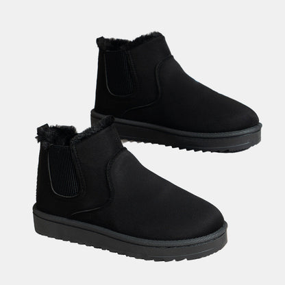 Black cozy ankle boots with faux fur trim and elastic side gusset, grippy sole