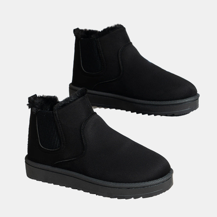 Black cozy ankle boots with faux fur trim and elastic side gusset, grippy sole