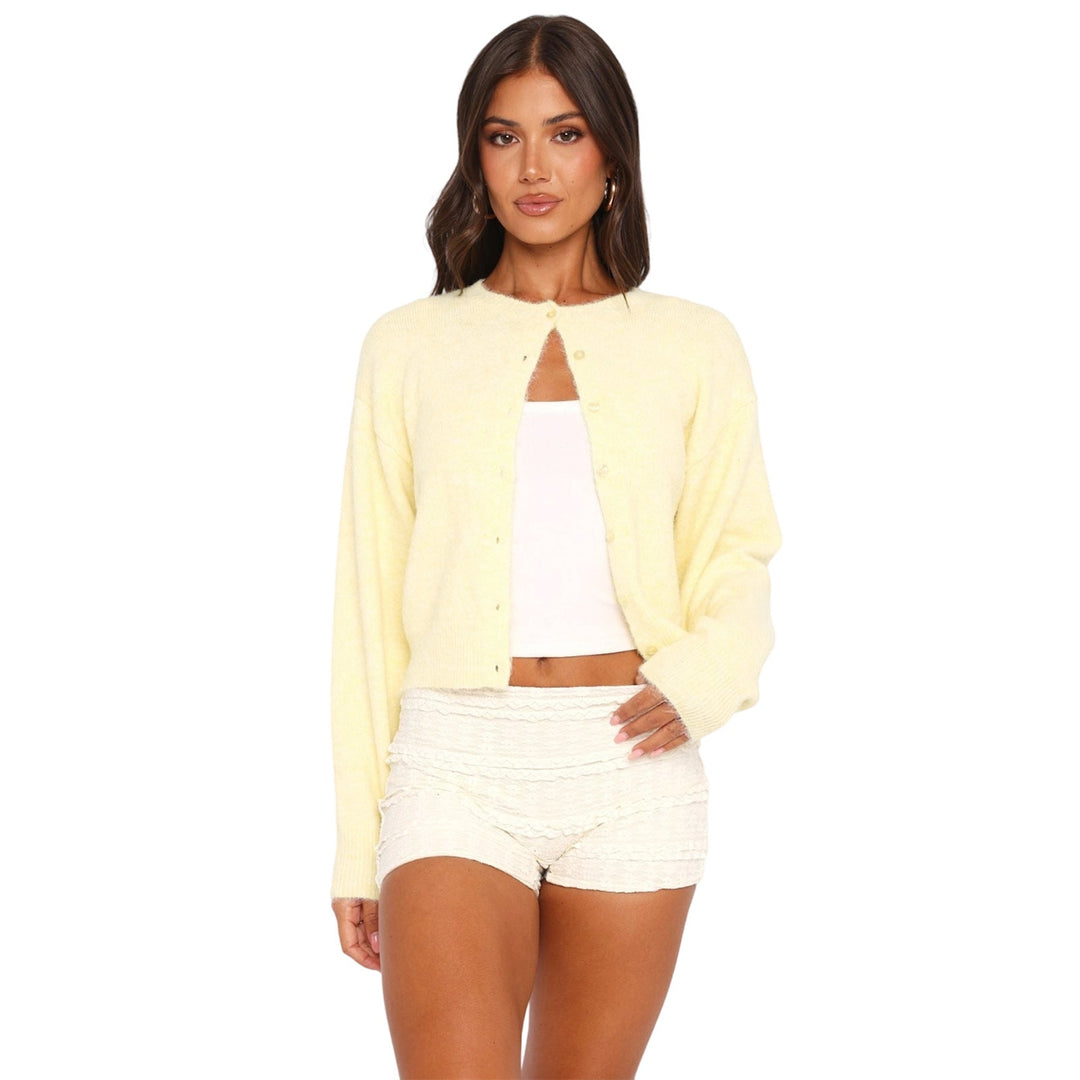 Cream cropped cardigan with long sleeves and button-front closure