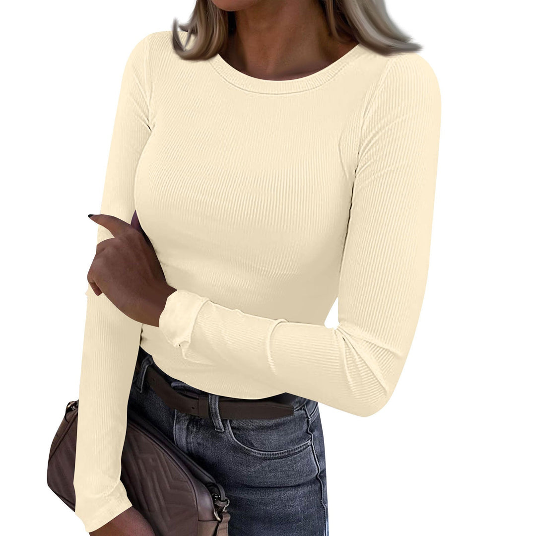 Casual crewneck ribbed long-sleeve top in cream, fitted fit, stretchy knit texture.