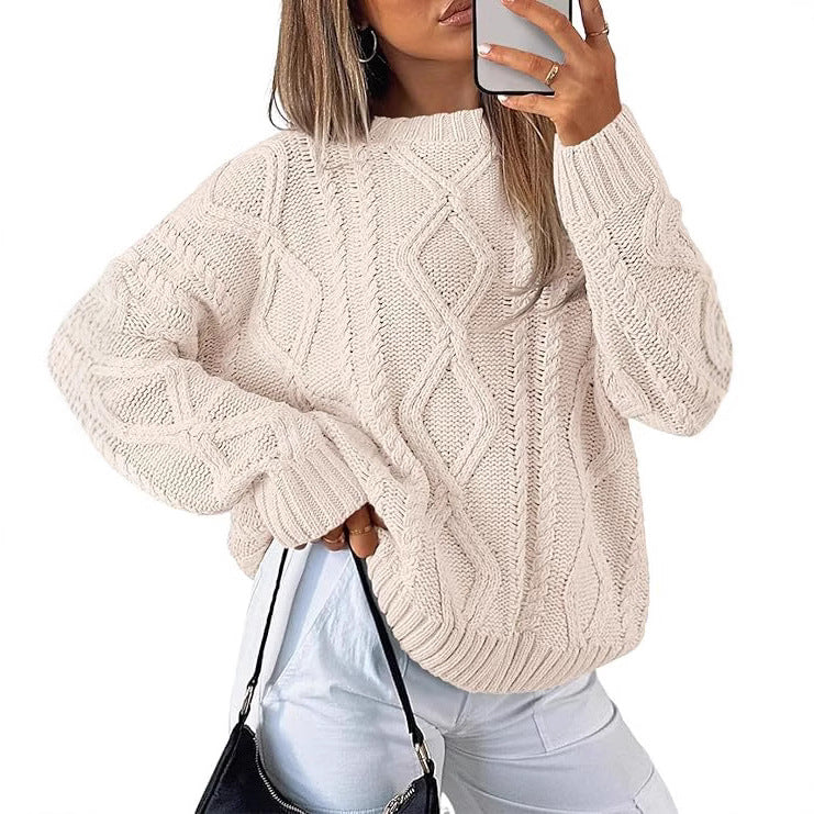 Light cream oversized cable-knit sweater with long sleeves and crew neck