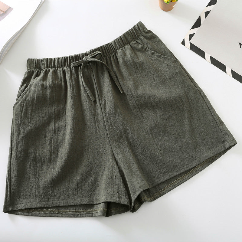 Olive green relaxed-fit shorts with elastic waistband and drawstring tie