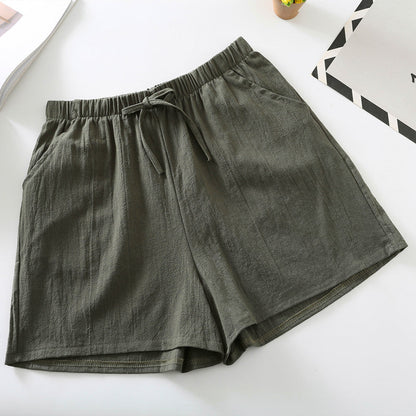 Olive green relaxed-fit shorts with elastic waistband and drawstring tie