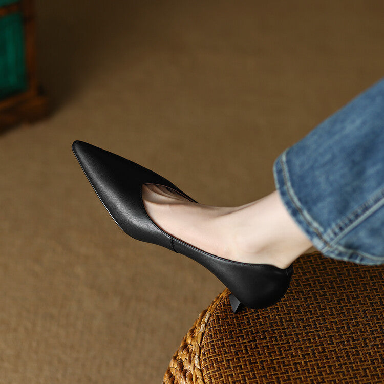 Black pointed-toe elegant pumps with low block heel, close-up on side profile