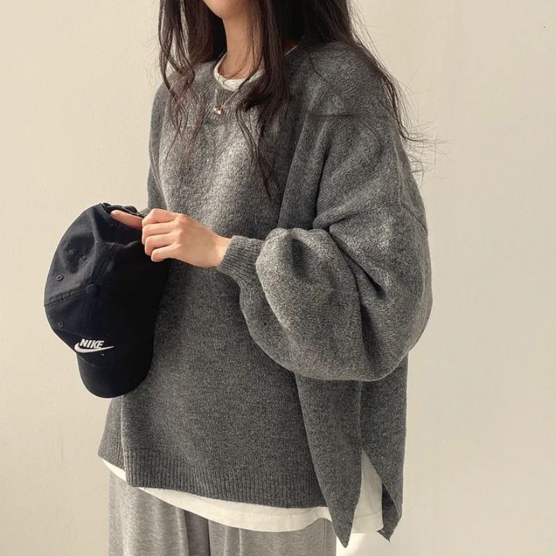 Grey oversized knit sweater with crew neck, long sleeves, ribbed cuffs and hem.
