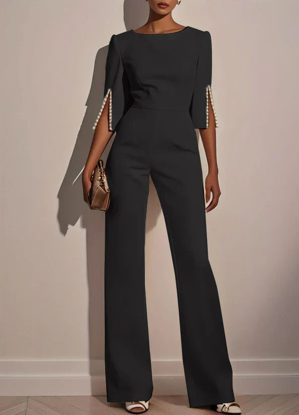 Black three-piece set with fitted top and wide-leg pants, embellished bell sleeves