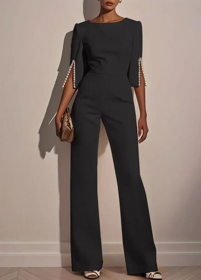 Black three-piece set with fitted top and wide-leg pants, embellished bell sleeves