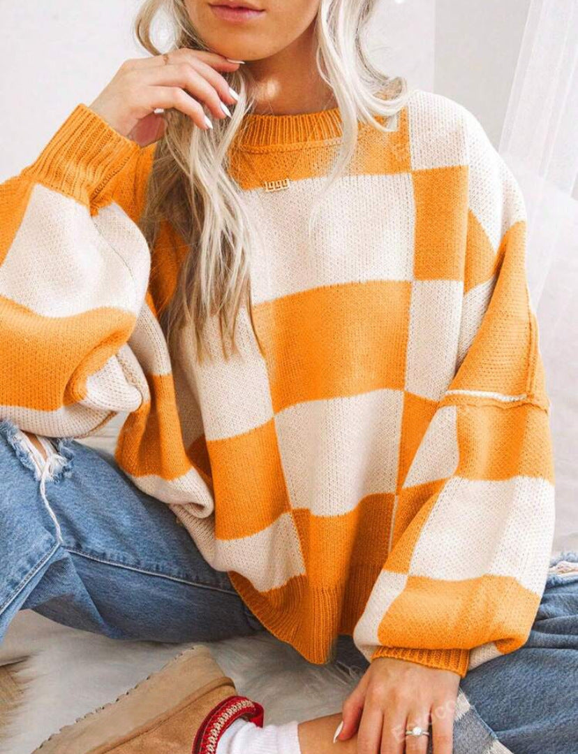 PILDA™ sweater in orange-and-white check, crew neck, loose long sleeves.