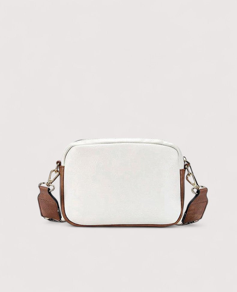 White lightweight crossbody bag with zip top and brown side panels.