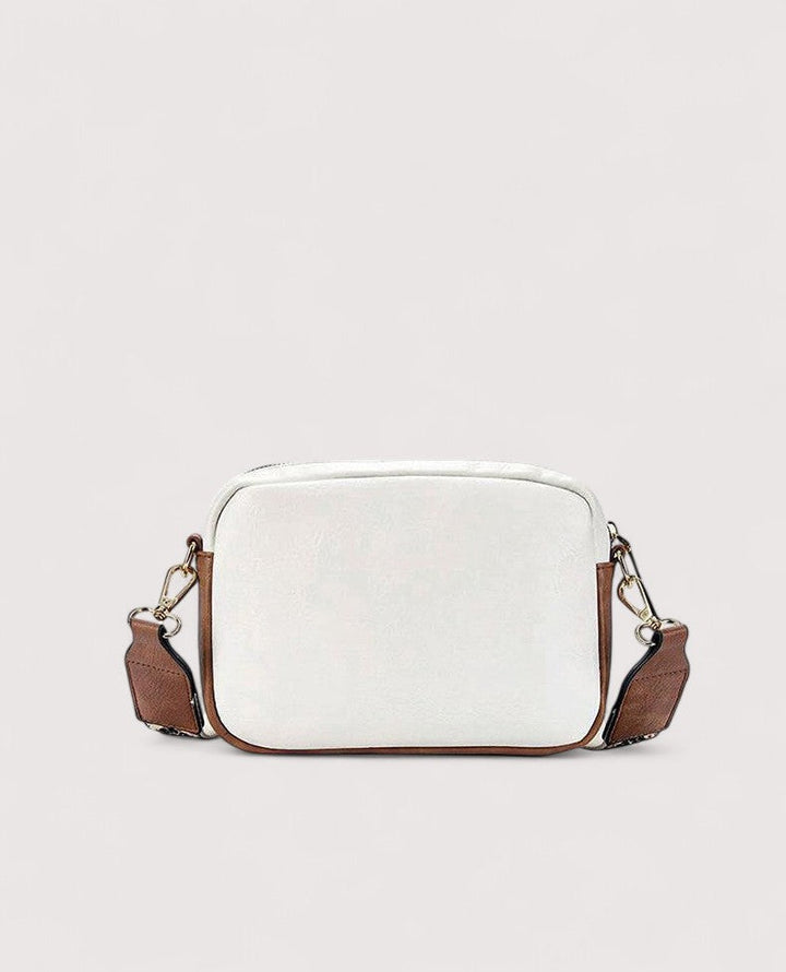 White lightweight crossbody bag with zip top and brown side panels.