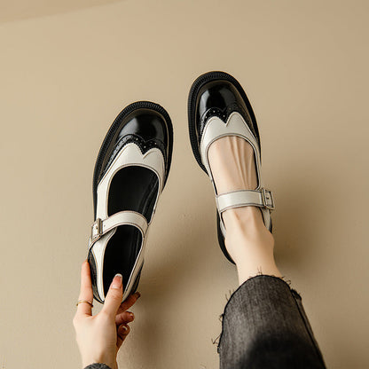 Black Mary Jane shoes with white strap and decorative wingtip detailing