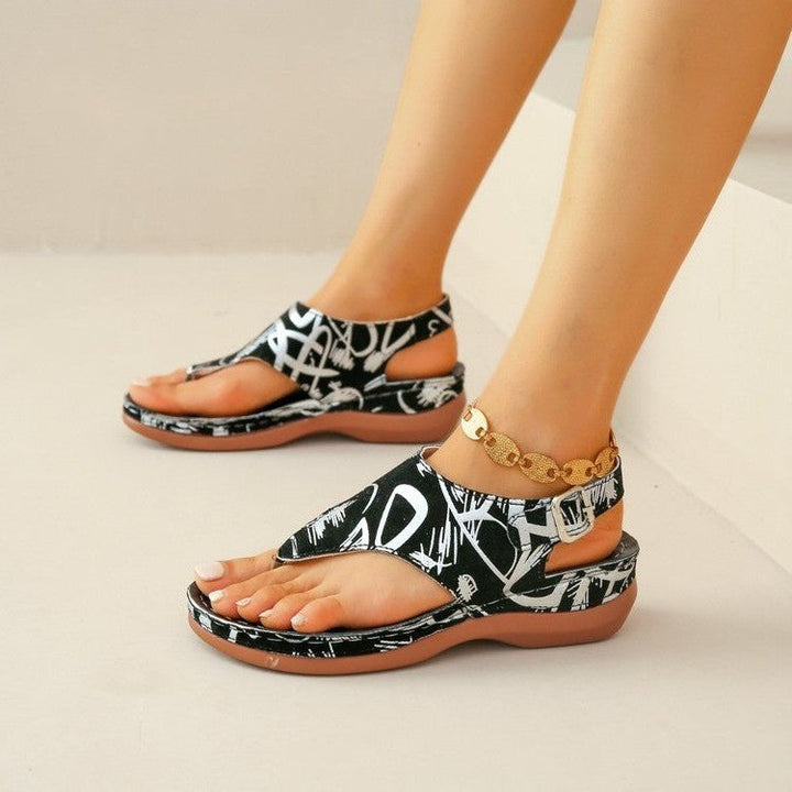 Black-and-white graphic orthopedic comfort sandals with open toe and gold chain ankle strap