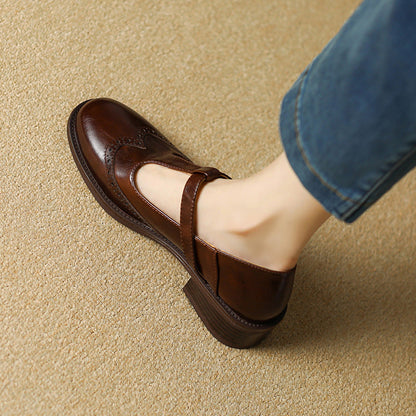 Brown Mary Jane shoes with T-strap buckle and perforated wingtip detail