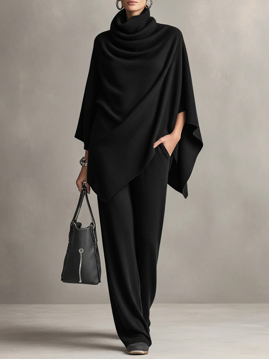 Black draped cowl-neck top with asymmetrical cape sleeves and wide-leg trousers